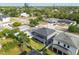 A high angle showcases the backyard, screened in lanai, and manicured lawn at 4007 W Gray St, Tampa, FL 33609