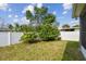 Fenced backyard featuring a well-maintained lawn and lush landscaping at 4007 W Gray St, Tampa, FL 33609