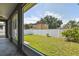 View of a fully fenced backyard featuring well maintained lawn and a small storage shed at 4007 W Gray St, Tampa, FL 33609