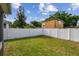 Fenced backyard featuring a well-maintained lawn and a shed for extra storage at 4007 W Gray St, Tampa, FL 33609