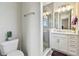 Well lit bathroom featuring a modern vanity, shower with glass doors, and a neutral color palette at 4007 W Gray St, Tampa, FL 33609