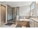 A luxurious bathroom with a glass enclosed shower, large soaking tub, and a dual sink vanity with modern fixtures at 4007 W Gray St, Tampa, FL 33609