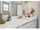 Bathroom vanity with a framed mirror, a decorative plant and great natural lighting at 4007 W Gray St, Tampa, FL 33609