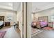 View of bedrooms with wood flooring, one with a pink ceiling fan at 4007 W Gray St, Tampa, FL 33609