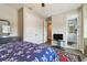 Bedroom with a ceiling fan, mirrored dresser and en-suite bathroom at 4007 W Gray St, Tampa, FL 33609
