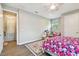 Bright bedroom featuring colorful accents, wood floors, natural light, and a pink ceiling fan at 4007 W Gray St, Tampa, FL 33609