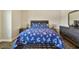 Bedroom featuring a neutral wall, wood floors, and dark colored furniture at 4007 W Gray St, Tampa, FL 33609