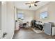 This bedroom features wood floors, two windows for natural light, and is staged as a home office at 4007 W Gray St, Tampa, FL 33609