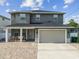 Inviting two-story home with a brick driveway and a two-car garage offers modern living at 4007 W Gray St, Tampa, FL 33609