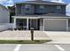 Charming two-story home with a paved driveway, covered porch, and well-manicured front yard at 4007 W Gray St, Tampa, FL 33609