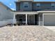 The exterior showcasing a two-story house with a paved driveway, covered porch, and manicured plants at 4007 W Gray St, Tampa, FL 33609