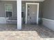 Inviting front porch with brick pavers and seating bench at 4007 W Gray St, Tampa, FL 33609