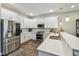 Bright kitchen features stainless steel appliances, white cabinetry, and sleek countertops at 4007 W Gray St, Tampa, FL 33609