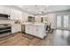Bright kitchen features white cabinetry, stainless appliances, and wood floors at 4007 W Gray St, Tampa, FL 33609