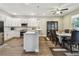 Open concept kitchen with white cabinets, stainless appliances, and adjoining dining area at 4007 W Gray St, Tampa, FL 33609