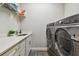 Laundry room equipped with stainless steel appliances, sink and storage cabinets at 4007 W Gray St, Tampa, FL 33609
