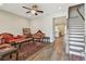 Elegant living room boasts hardwood floors, a ceiling fan, and a staircase at 4007 W Gray St, Tampa, FL 33609