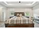 This spacious main bedroom features a bed with end tables and wood floors at 4007 W Gray St, Tampa, FL 33609