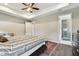 A spacious main bedroom featuring a trey ceiling, fan, and a modern ensuite bathroom for added convenience at 4007 W Gray St, Tampa, FL 33609