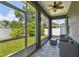 Screened in porch featuring neutral furniture, a ceiling fan and multiple windows at 4007 W Gray St, Tampa, FL 33609