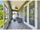 Screened in porch with neutral toned furniture and view of the fenced backyard at 4007 W Gray St, Tampa, FL 33609