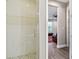 Tiled shower with glass enclosure and pebble floor at 4007 W Gray St, Tampa, FL 33609