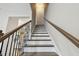 This home features a staircase with wood handrail and iron balusters at 4007 W Gray St, Tampa, FL 33609