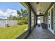 Sunroom showing neutral colored tile, wicker furniture and great view to back yard at 4007 W Gray St, Tampa, FL 33609