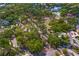 A high angle aerial view of a circular street surrounding a vacant lot filled with trees at 4302 W Woodmere Rd, Tampa, FL 33609