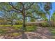 Charming one-story home with a brick driveway and mature landscaping providing ample shade at 4302 W Woodmere Rd, Tampa, FL 33609