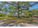 Charming one-story home with a brick driveway and mature landscaping providing ample shade at 4302 W Woodmere Rd, Tampa, FL 33609
