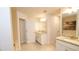 Bright bathroom featuring dual vanities with granite countertops, modern lighting, and a separate toilet room at 4444 Boyer Ter, North Port, FL 34288