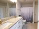 Modern bathroom featuring dual sinks, granite counters, and a stylish shower curtain at 4444 Boyer Ter, North Port, FL 34288
