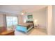Bedroom features a teal headboard, ceiling fan, light walls, and light floors at 4444 Boyer Ter, North Port, FL 34288