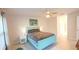Bedroom features a teal headboard, ceiling fan, light walls, and light floors at 4444 Boyer Ter, North Port, FL 34288