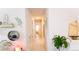 Bright hallway features tile floors and neutral decor with decorative shelves and art at 4444 Boyer Ter, North Port, FL 34288