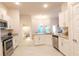Modern kitchen with white cabinets, granite countertops, and stainless steel appliances at 4444 Boyer Ter, North Port, FL 34288