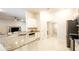 Open kitchen with granite countertops, stainless steel appliances, and views of the living room at 4444 Boyer Ter, North Port, FL 34288