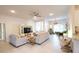 Open-concept living room with neutral furniture, tile floors, and access to the dining and kitchen area at 4444 Boyer Ter, North Port, FL 34288