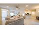 Bright living room with neutral tones, tile floors and open concept layout to the kitchen at 4444 Boyer Ter, North Port, FL 34288