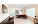 Cozy home office with a leather couch, a wooden desk, and natural light at 4444 Boyer Ter, North Port, FL 34288