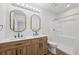 Well-lit bathroom with double vanity, modern mirrors, and walk-in shower at 4701 14Th S Ave, St Petersburg, FL 33711