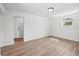 Minimalist bedroom featuring light-colored, wood-look floors, neutral white walls, and modern ceiling lighting at 4701 14Th S Ave, St Petersburg, FL 33711
