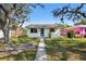 Charming single story home with blue door, white paint and well manicured yard at 4701 14Th S Ave, St Petersburg, FL 33711