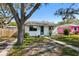 Charming single story home with blue door, white paint and well manicured yard at 4701 14Th S Ave, St Petersburg, FL 33711