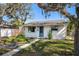 Charming single story home with blue door, white paint and well manicured yard at 4701 14Th S Ave, St Petersburg, FL 33711