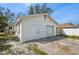 Garage exterior with two white access doors in addition to a larger garage door for vehicle storage at 4701 14Th S Ave, St Petersburg, FL 33711