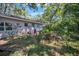 Backyard featuring a garden area, lush plants, and mature trees at 503 W Lee St, Plant City, FL 33563