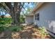 Backyard featuring mature landscaping and a large tree at 503 W Lee St, Plant City, FL 33563