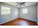 Comfortable bedroom with hardwood floors, ceiling fan, and ample natural light at 503 W Lee St, Plant City, FL 33563